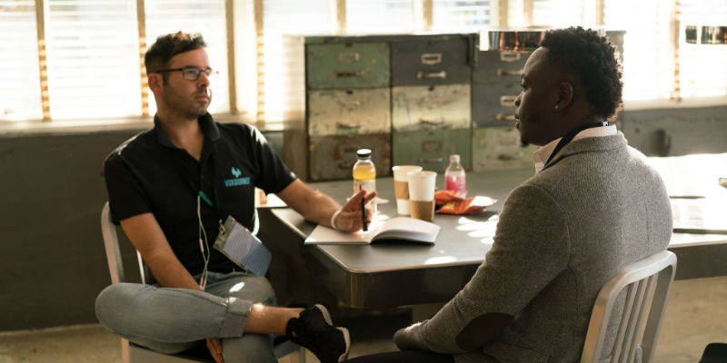 Two people sitting down and talking