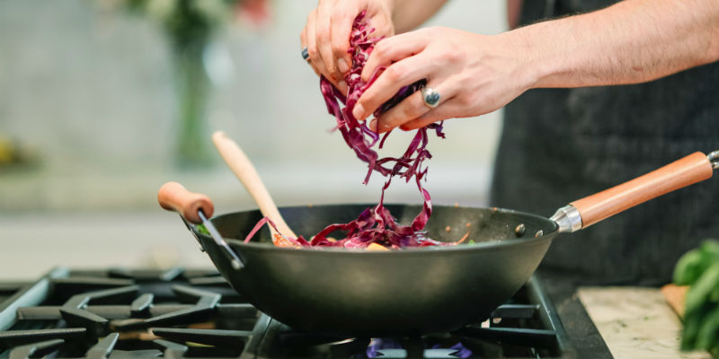 Person cooking on a propane stove