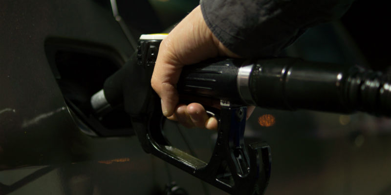 A person using a vehicle gas pump